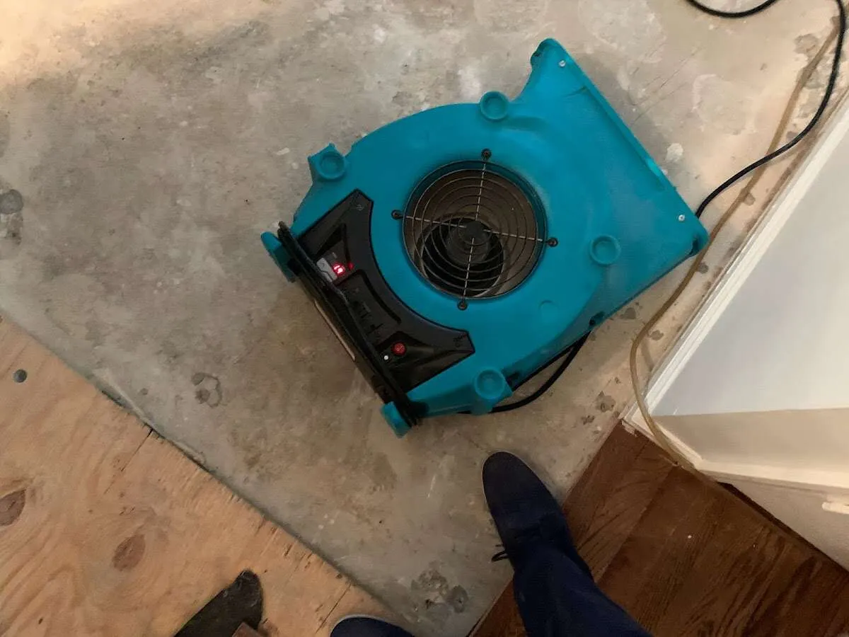Air mover drying subfloor during Commercial Water Damage Restoration in Mayfield Heights